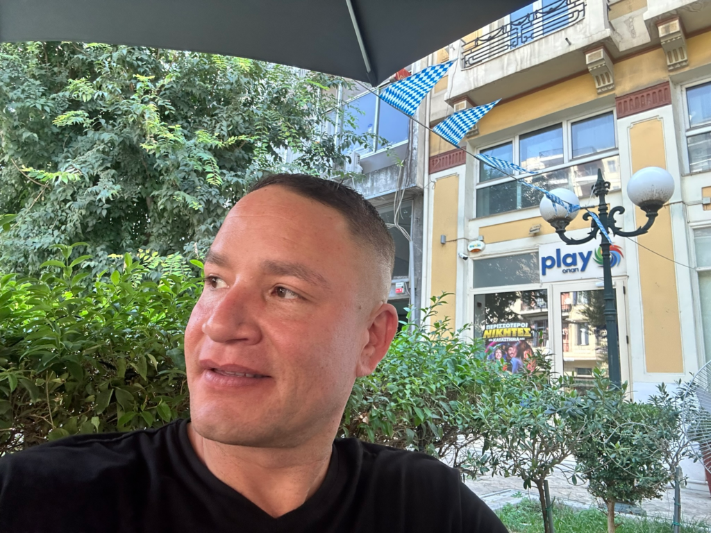 Ian enjoying a moment outside at a café
